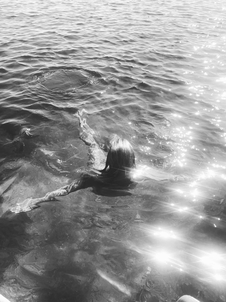 Woman swimming in reflective water